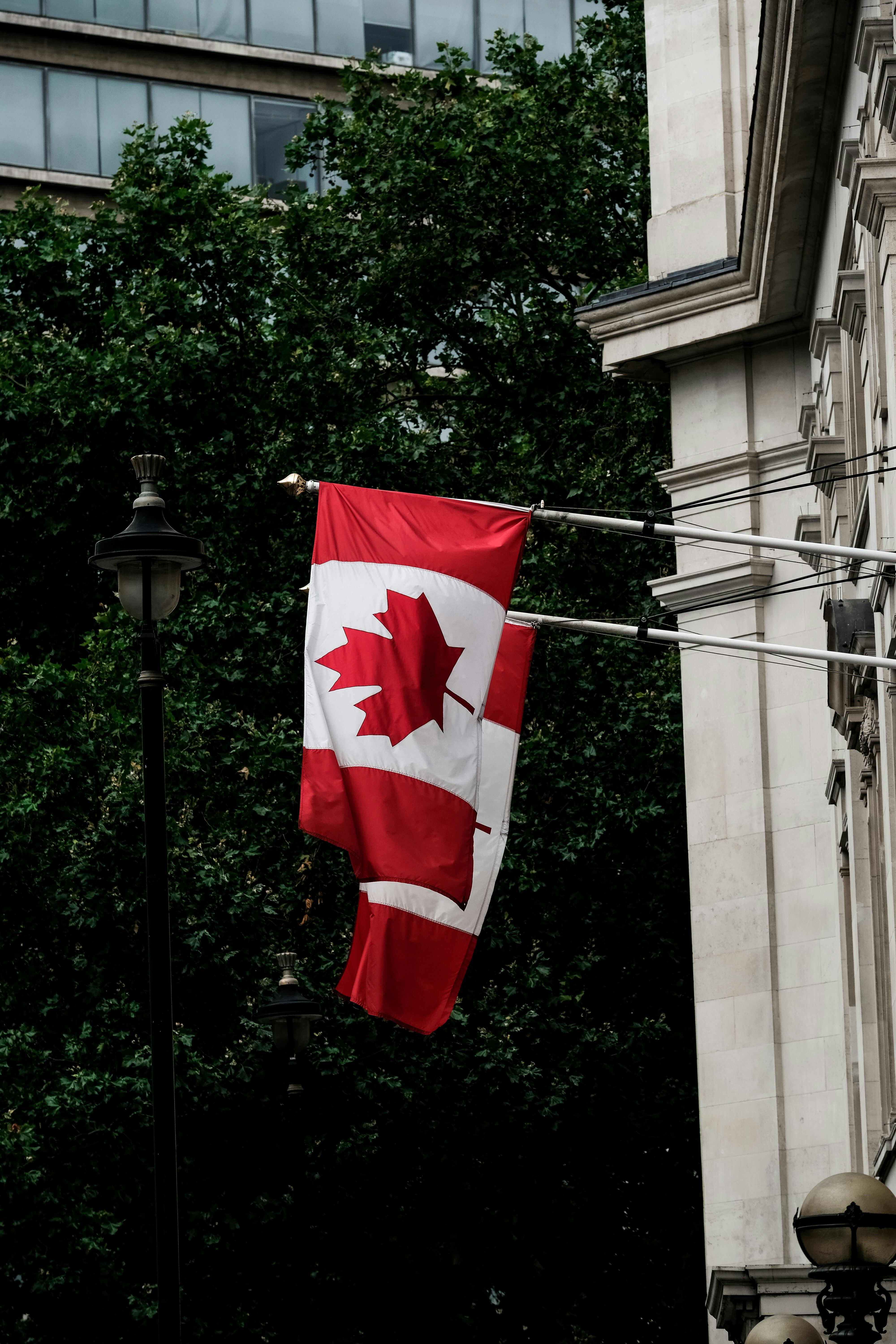 Image of two Canadian flags draped on the side of an Institution